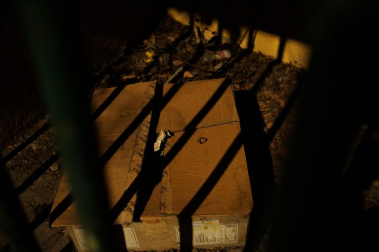 abandoned cardboard box in shadow