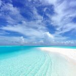 photo of beach under blue sky scenery