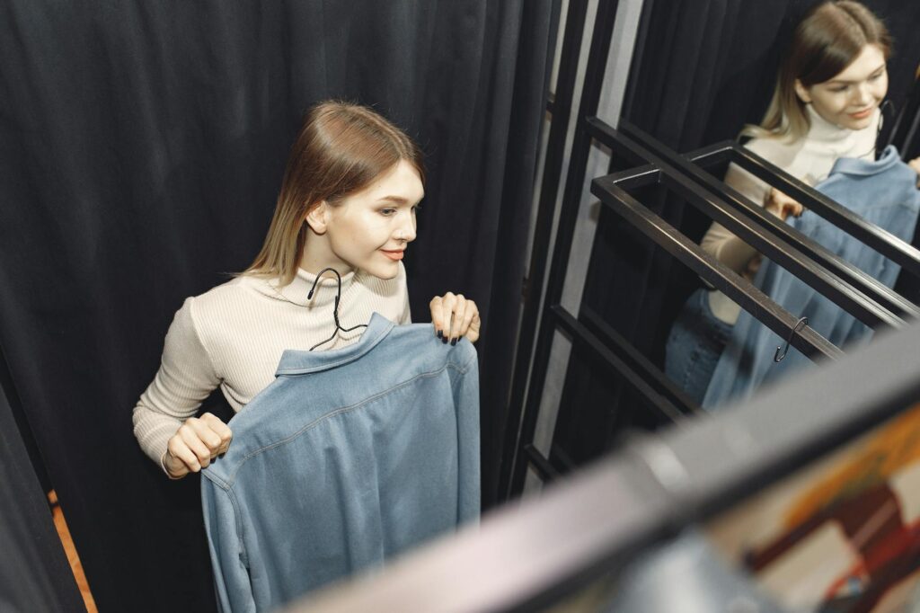 woman holding a denim top