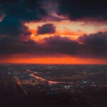 aerial shot of a city under a cinematic sky
