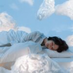 photo of a woman sleeping near fluffy clouds