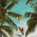 people with surfboards on a beach
