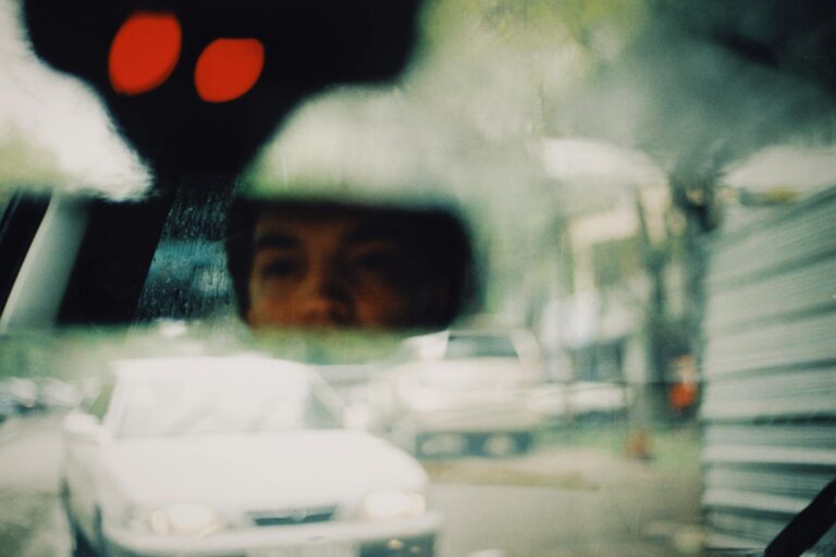 a reflection of a person on the car s head mirror