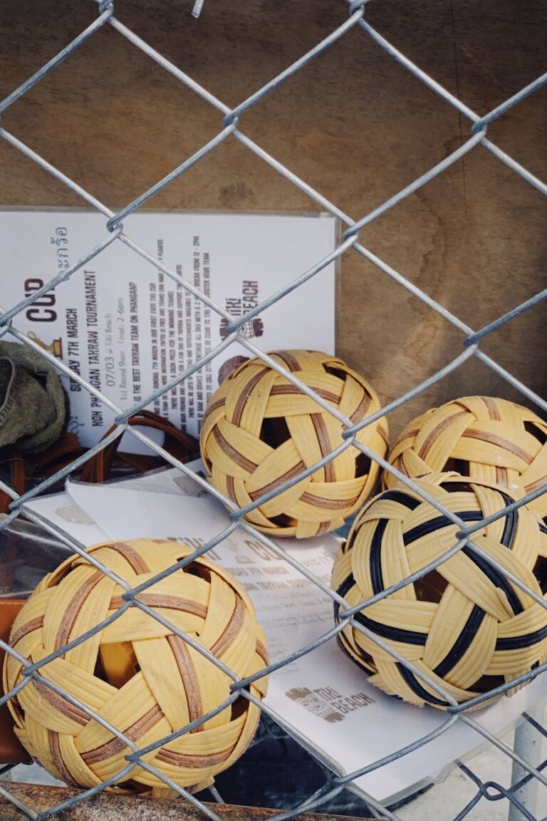 sepak takraw balls behind chain link fence