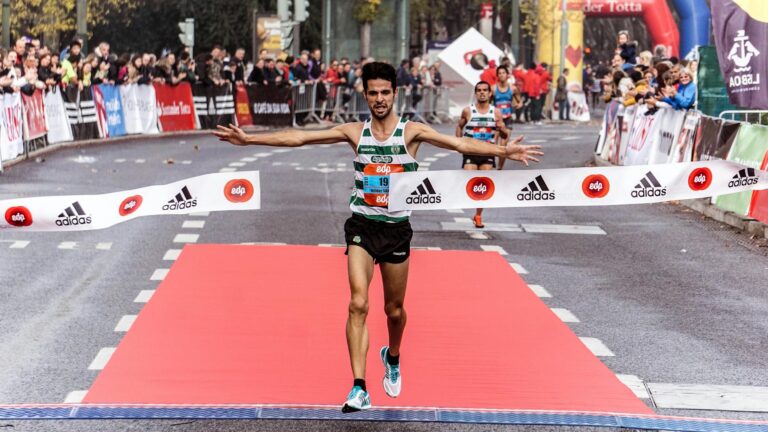 man running on black asphalt road