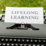 a typewriter with a paper that says life long learning
