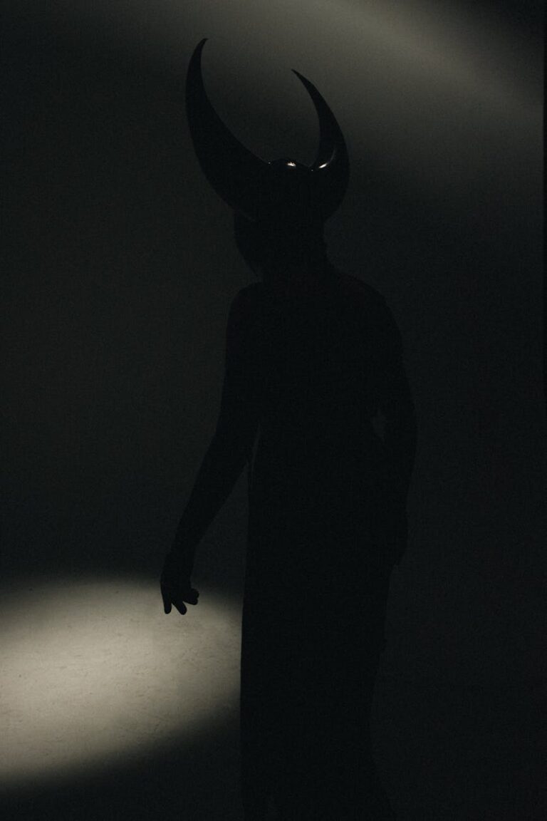 person in costume with horns standing in darkness