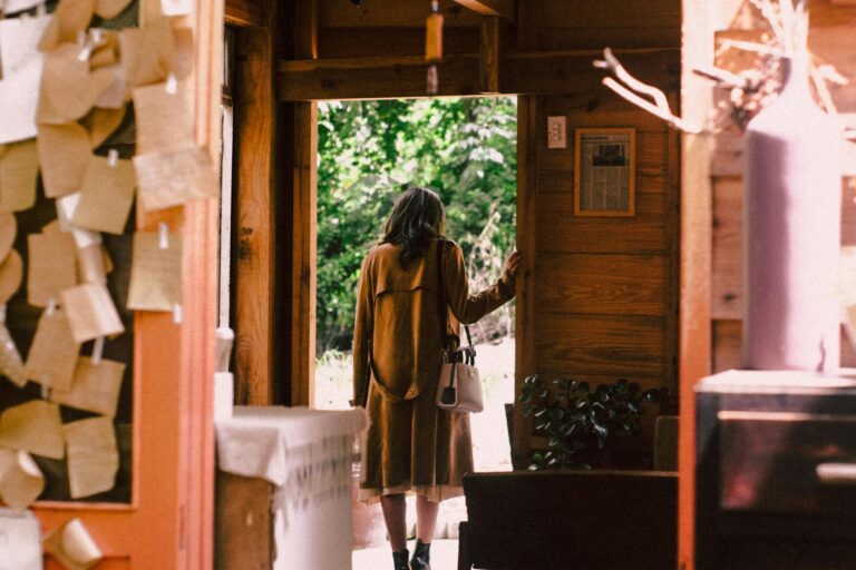 woman standing near open door about to step outside