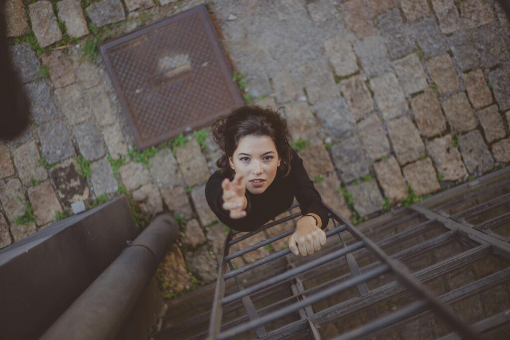 photo of woman climbing on ladder