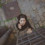 photo of woman climbing on ladder