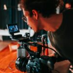 photo of a man holding video camera