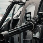 close up photo of black helicopter with black machine gun