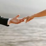 romantic couples hands with wedding rings