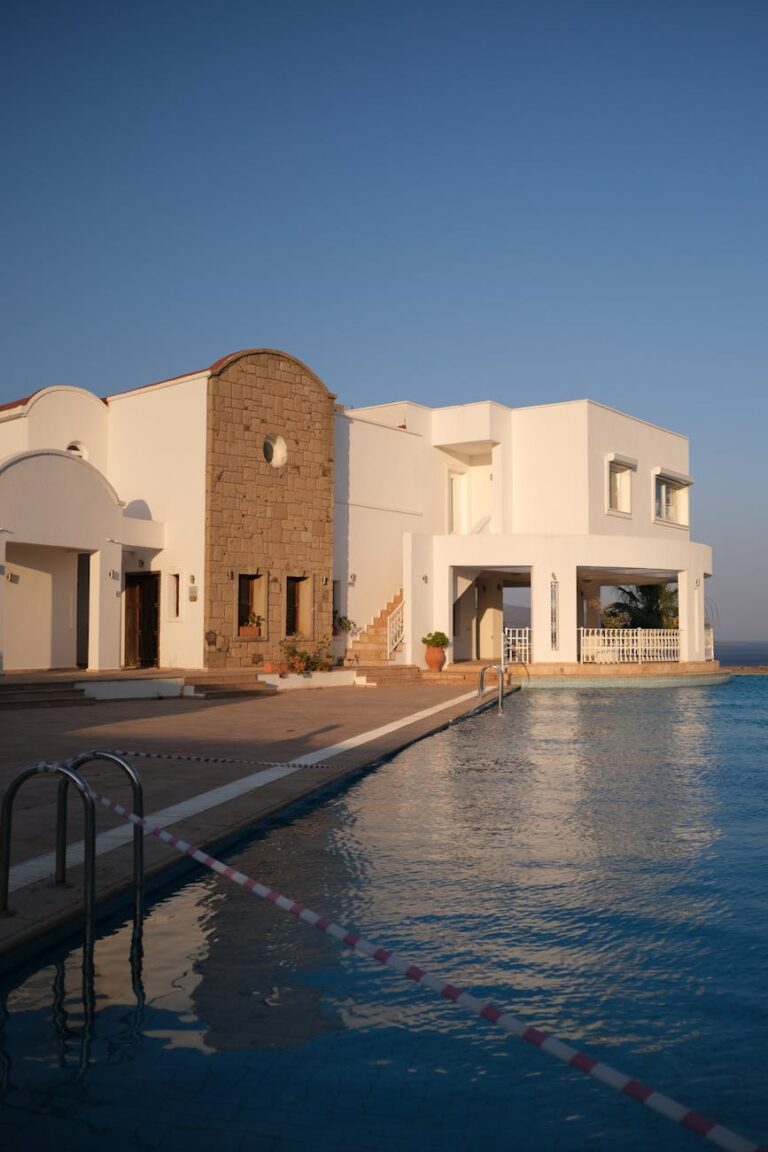 modern seaside villa with pool at sunset
