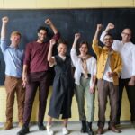 group of people standing infront of blackboard