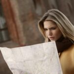 woman in brown long sleeve shirt holding map