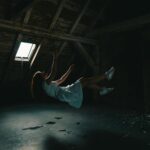 woman in white dress falling on gray concrete floor