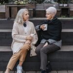 women sitting on the bench while talking