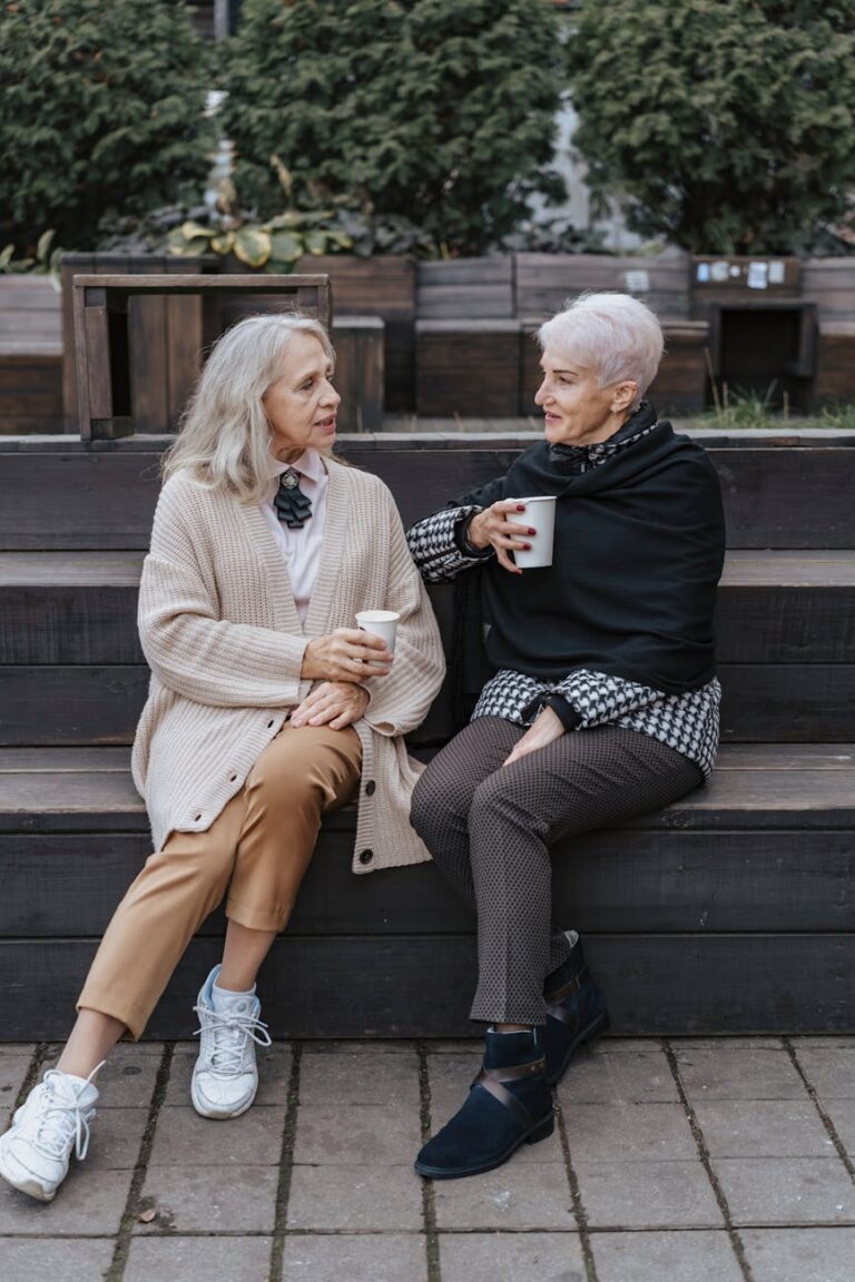 women sitting on the bench while talking