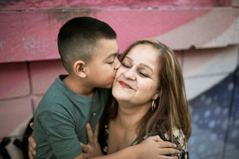 a boy kissing his mother