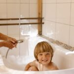 a boy bathing in a bathtub