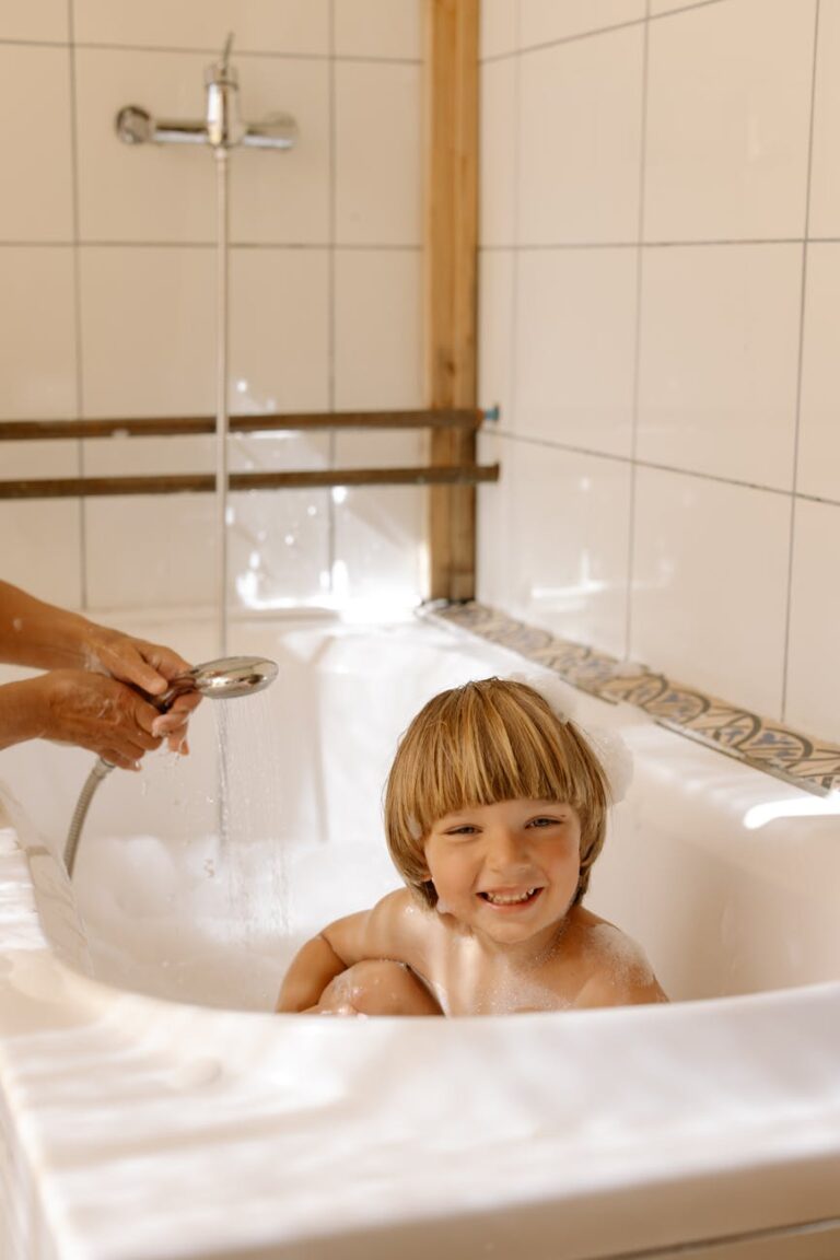 a boy bathing in a bathtub