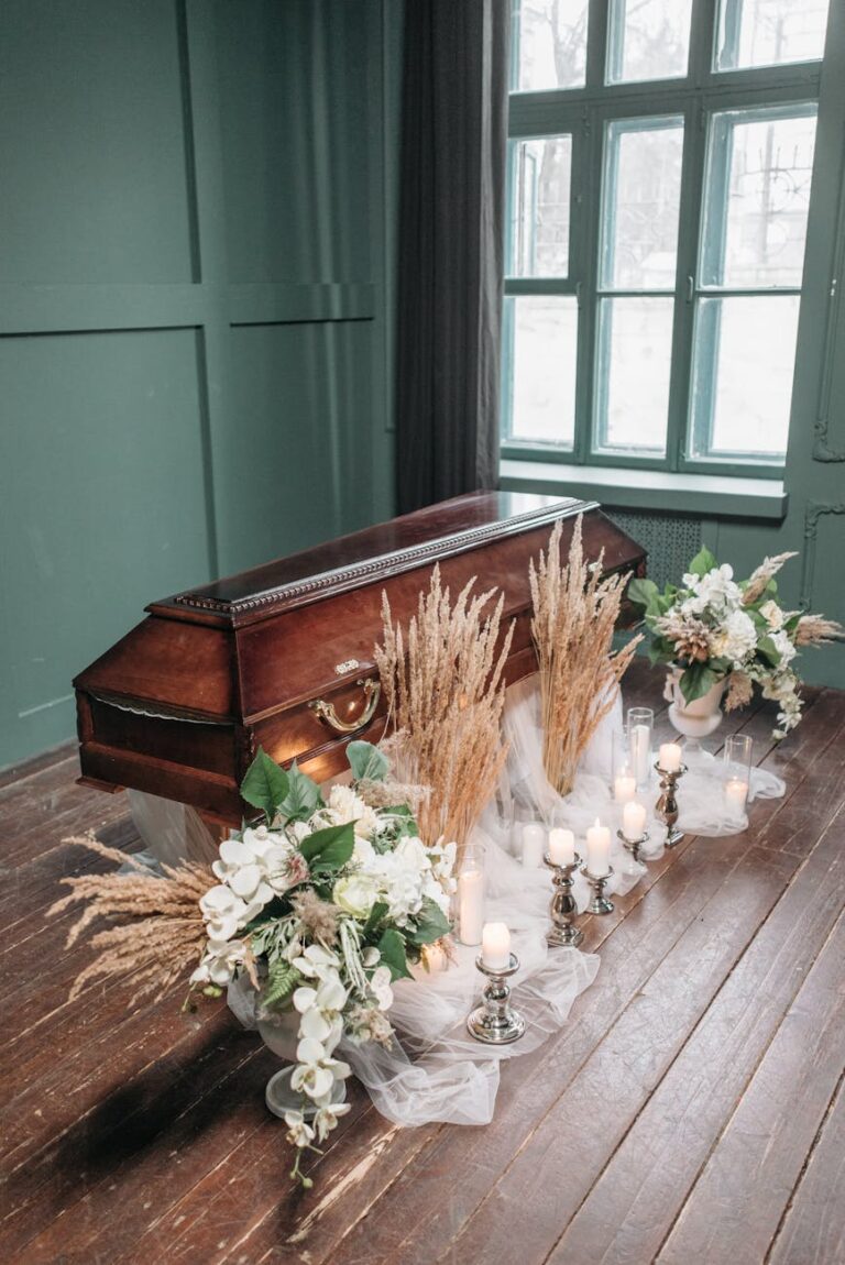 a brown wooden coffin decorated with white flowers on the floor