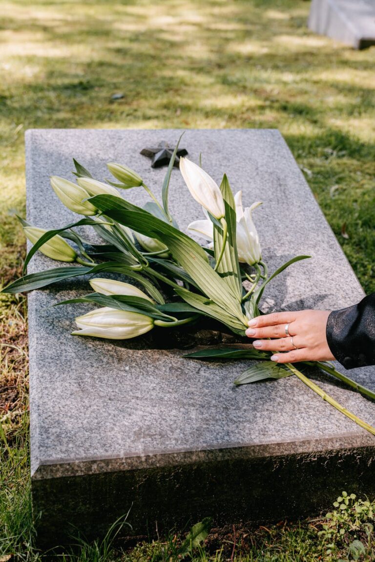 laying flowers over a tombstone
